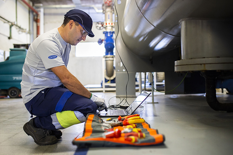 Carrier’s service technician gathering data.