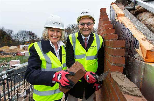 Beverley Webster OBE, chairman of the Health and Atulkumar Patel MBE lay the final brick to complete the structure of the new staff health and wellbeing hub