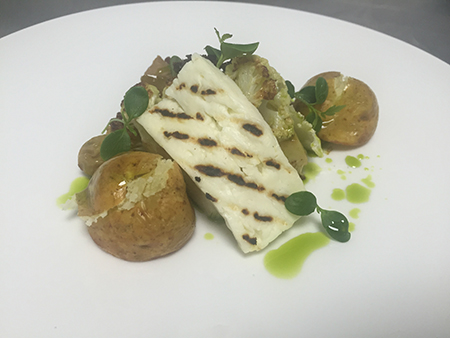 The vegetarian starter option is Cauliflower, halloumi, roasted potatoes, dried grapes with a pernod dressing