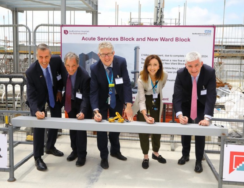 The topping-out ceremony was attended by Andrew Selous MP; Richard Sumray, chairman of Bedfordshire Hospitals; David Carter, chief executive of Bedfordshire Hospitals; Melanie Banks, director of redevelopment and strategic planning at Bedfordshire Hospitals; and Andrew Davies, chief executive of Kier Group, who signed the final piece of steel making up the frame of the building