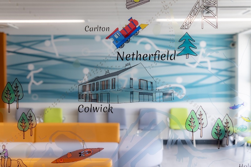 The interior design includes artwork reflecting the local area