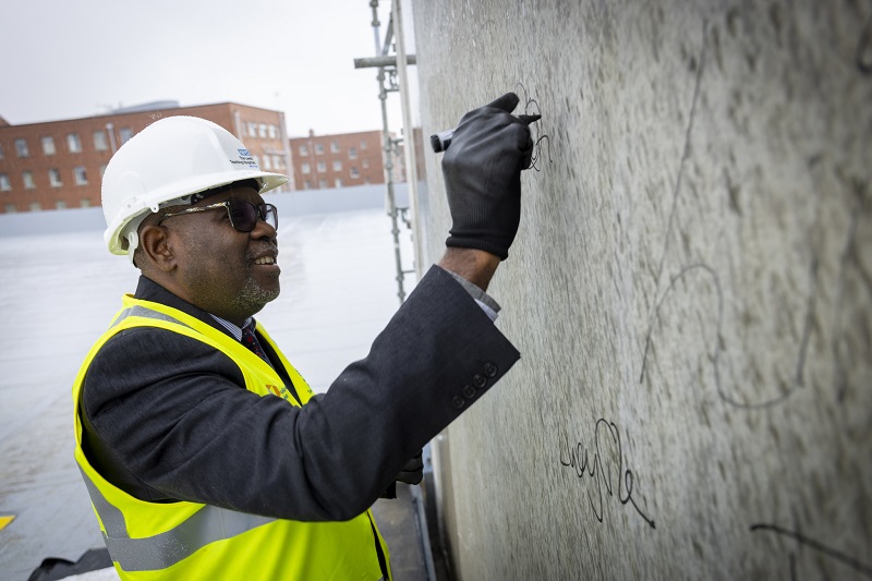 The topping-out ceremony saw key stakeholders signing the concrete stair core of the new building